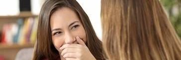 woman smiling, hiding her teeth